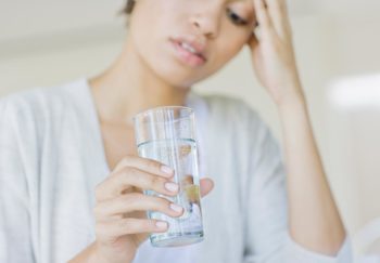 woman drinking her colonoscopy prep out of a glass