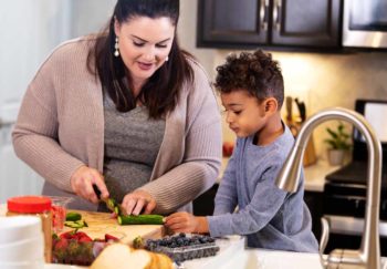 mother and son cutting vegetables