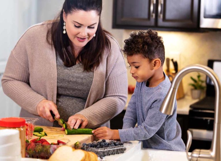 mother and son cutting vegetables