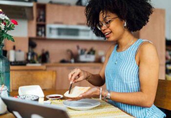 A woman spreading butter on bread